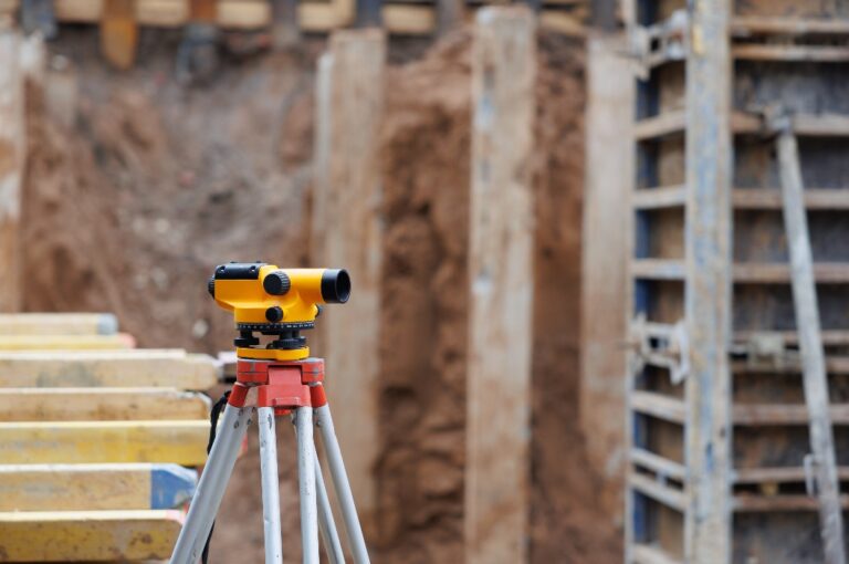 Tachymeter, an instrument for measuring, at a construction site - selective focus with little depth of field. construction of a high-rise building. Marking the piles in the building excavation